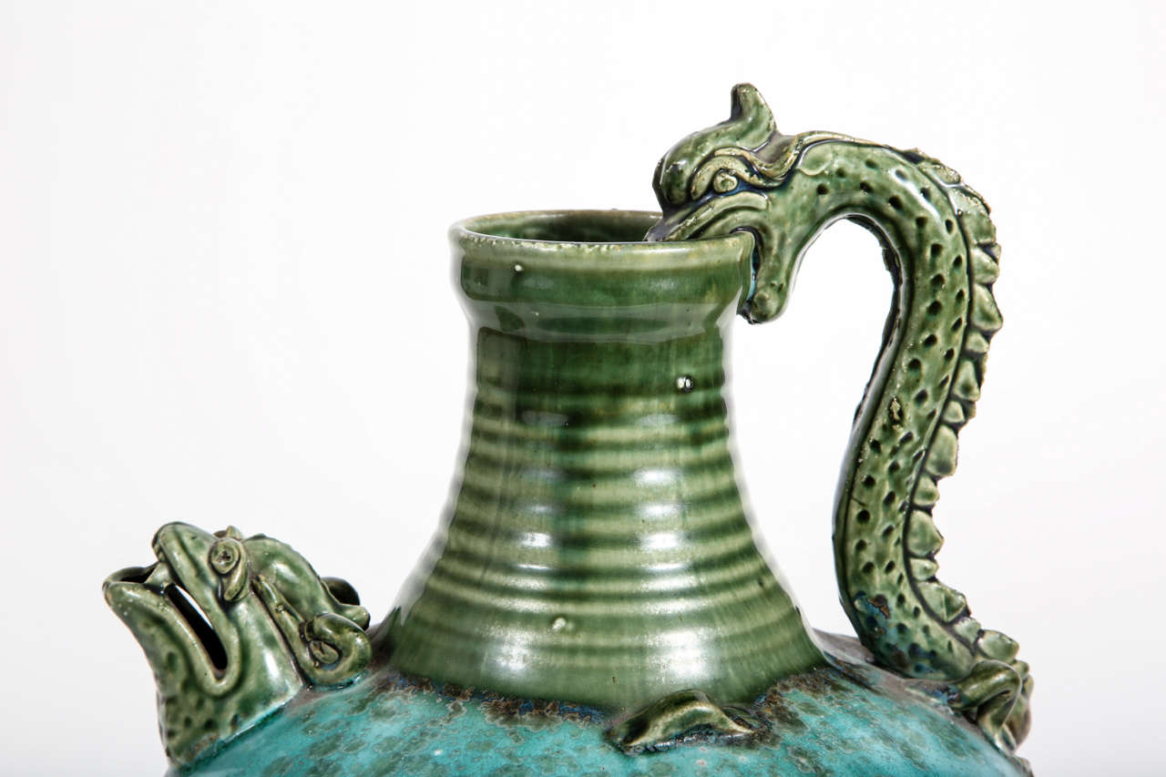 Earthenware vessel with dragon spout and handle.  Chocolate, turquoise and green glaze.