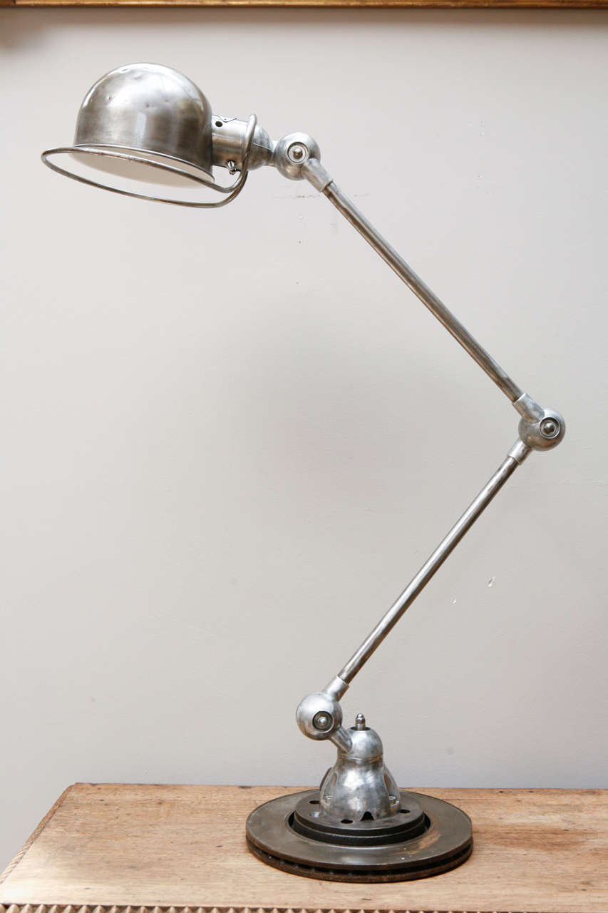 A metal Jielde adjustable lamp. Extends from approximately 19
