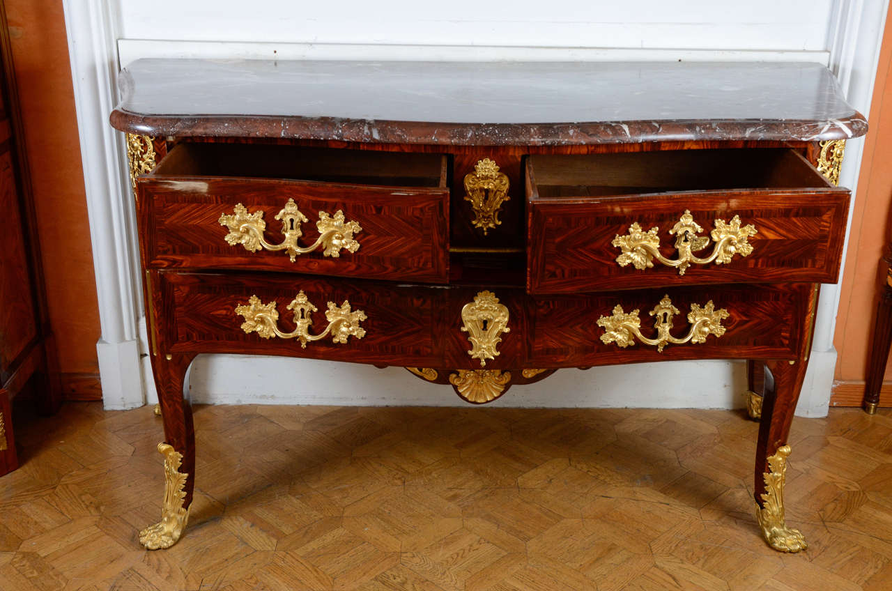 Two shorts and one long drawers , on cabriole legs.
red marble top with curved form.
Very nice ormoulu sabots  and  handles
