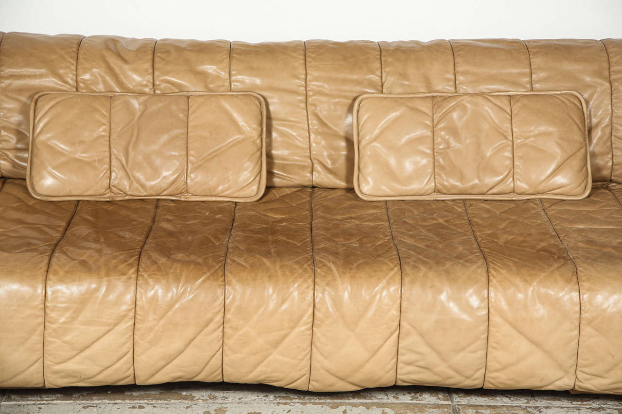 De Sede leather Sleeper Sofa made in Switzerland.  The arms pull forward and the seat back unrolls to form a bed. Matching ottoman available.