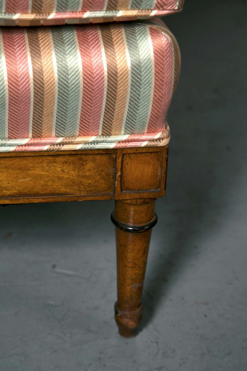 Fruitwood lounge chairs in striped fabric.