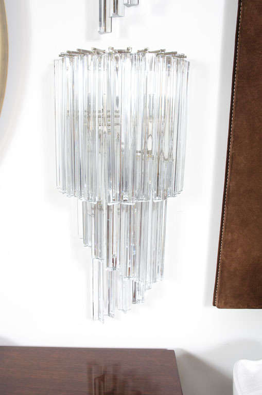 A pair of shimmering large sconces in a twisting cascade of triangular-shaped crystal rods with flat ends all suspended from a metal frame. By Camer Glass. Italy, circa 1960.