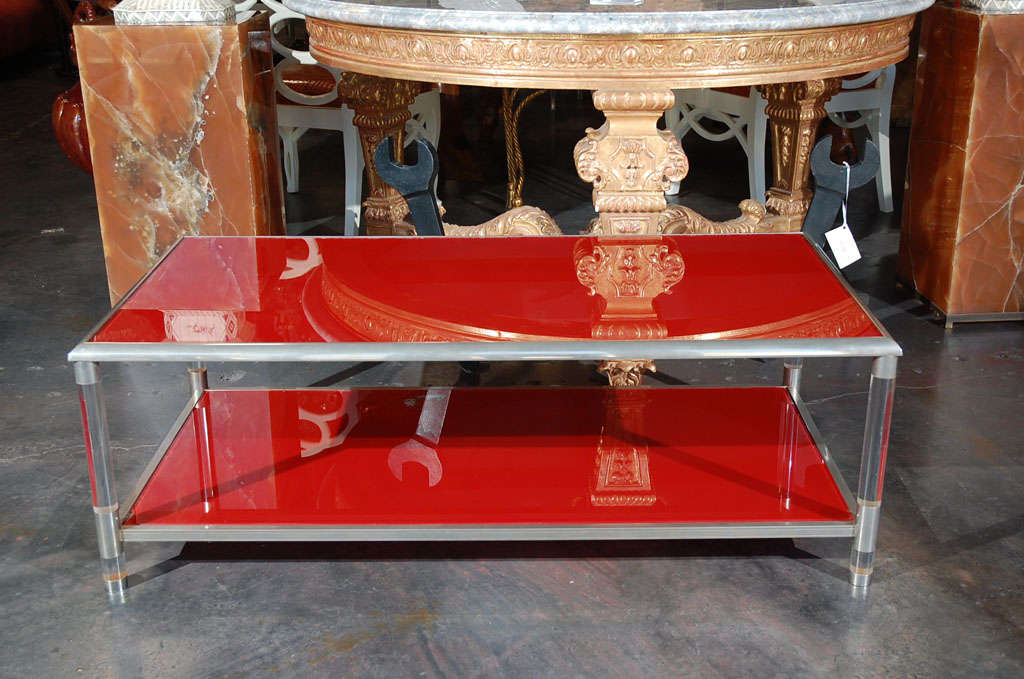 A gorgeous French coffee table. Made of glass, nickel and Lucite. Two levels of glass is reverse painted in red. Very stunning.