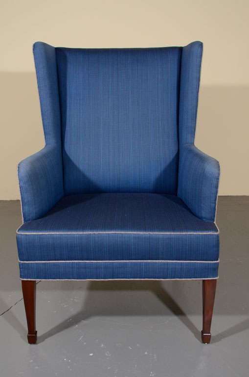 A Danish upholstered and mahogany wingback chair, possibly by Frits Henningsen, Circa 1940.