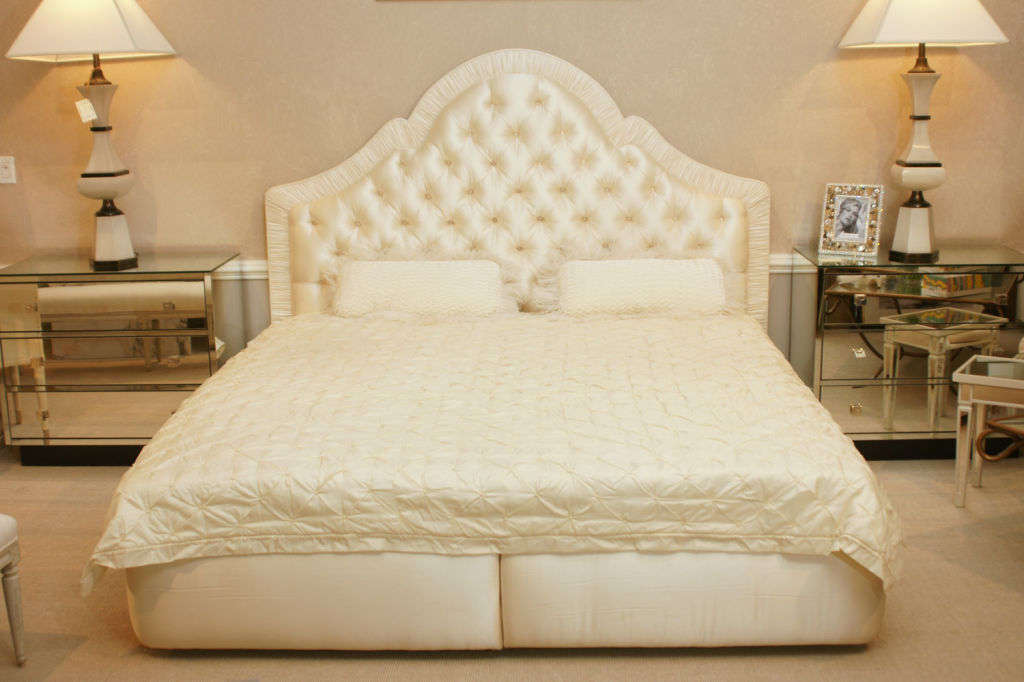 Magnificent Hollywood Regency style bed upholstered in brushed silk. The bed takes a standard king size mattress.