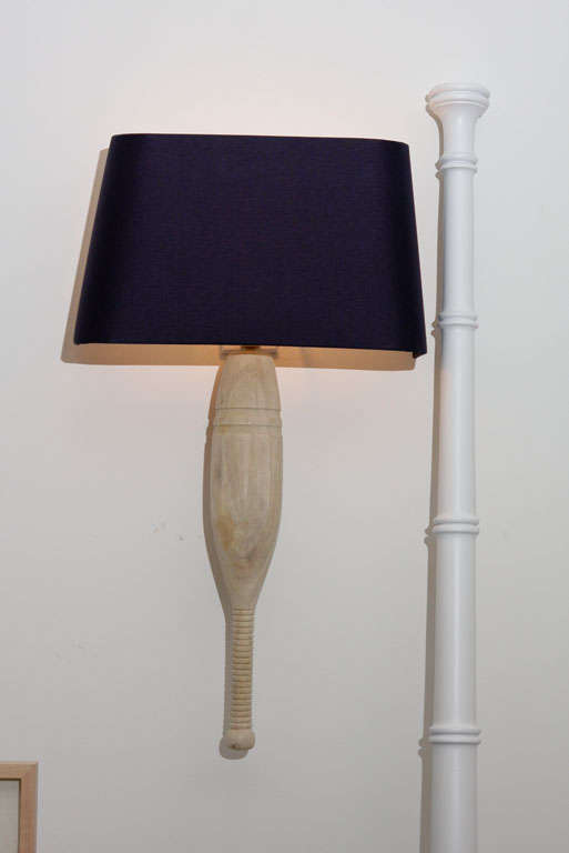 Vintage bowling pins,specially bleached in a Brussels Atelier.Accented with crisp,navy blue lampshades.