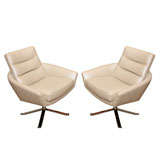 A Pair of Swivel Leather Arm Chairs