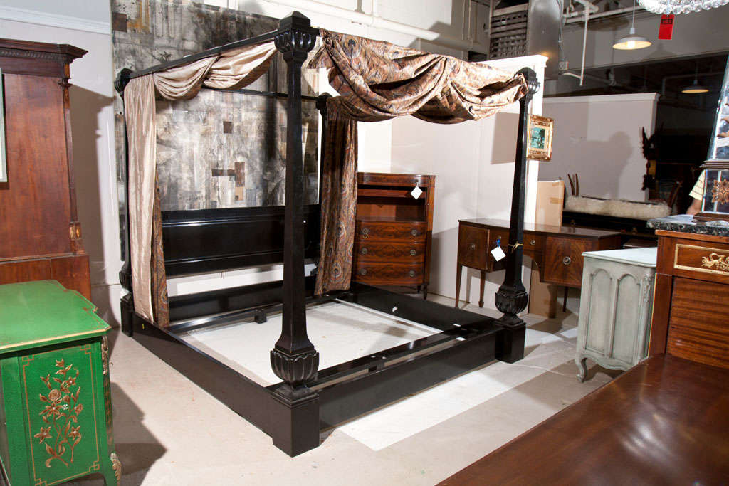 An overall ebonized canopy-style bed with column-shaped posts. Fitted for mattress 86 1/2 by 79.