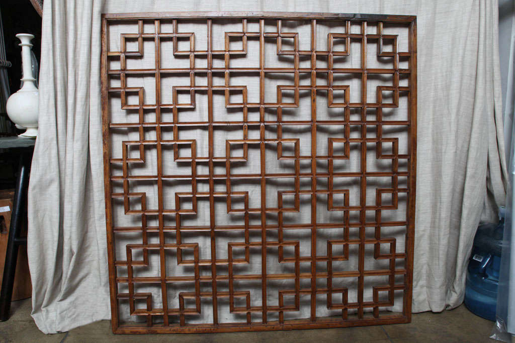 a Chinese lattice panel or screen. Shanxi, late 19th Century. Distinctive wall decor in a traditional interlocking pattern.  Available with mirrored backing, for an additional cost.