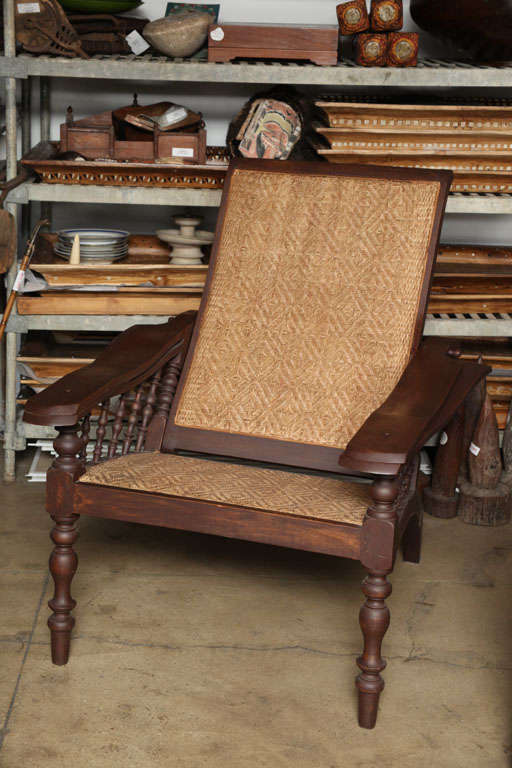 A large Burmese planter's lounge chair.  Adjustable back.  Cane seat and back.