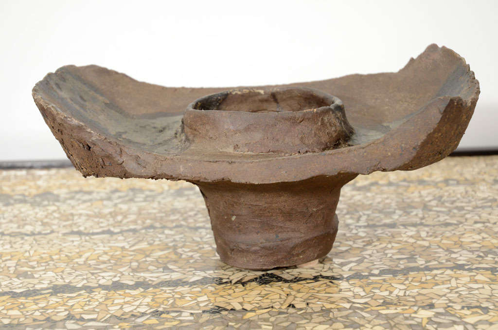 Asian inspired, footed vessel with rough edges and stripped coloring. This piece also has a central hole that runs into the central pedestal. Signed on bottom R.W.D.