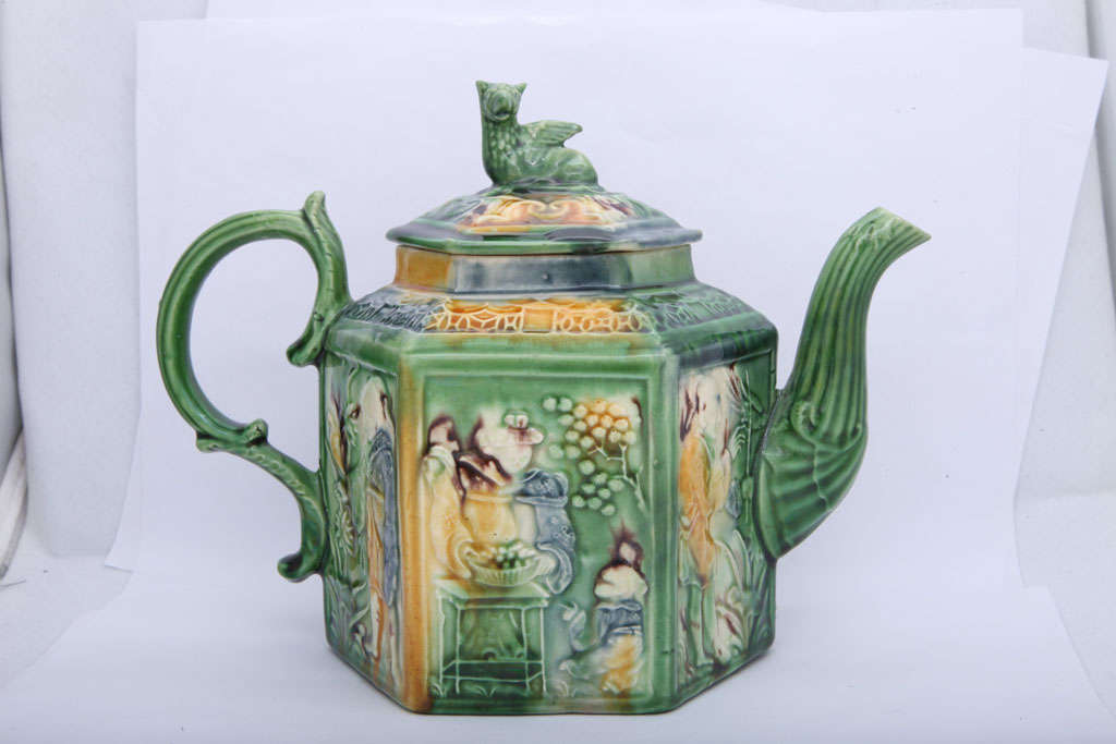 A rare Whieldon school hexagonal teapot molded with Oriental figure and birds and decoratedin underglaze oxide colors