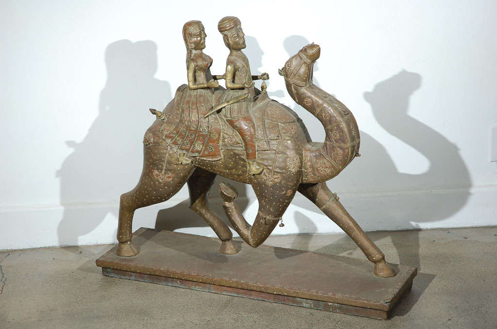 Temple decoration, Anglo Raj Indian couple for Rajasthani Wedding procession.
Great hand-crafted sculpture of a camel with a couple going to a wedding.
Hand-crafted in wood and covered with embossed brass.
