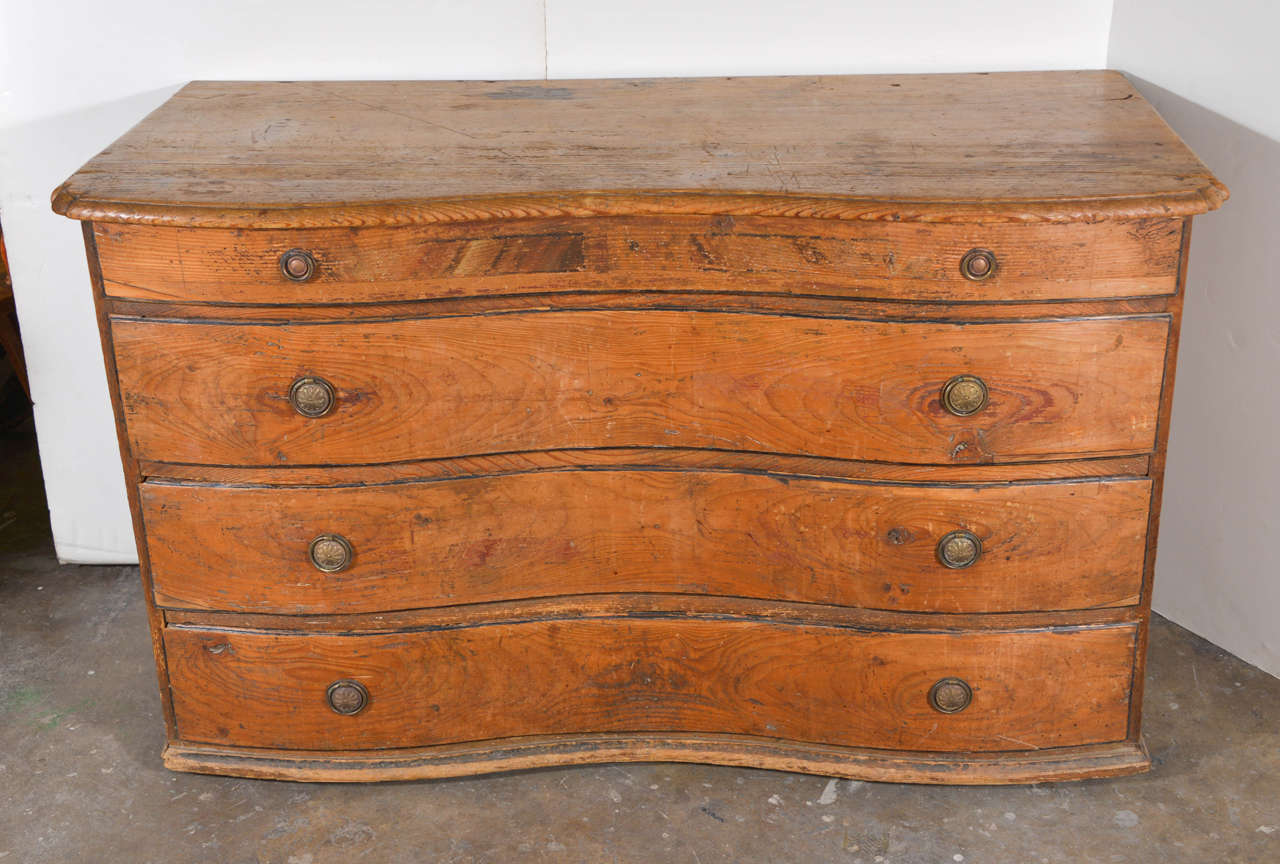 This beautiful serpentine shaped pine chest from Italy has it's original hardware.
Gorgeous patina with hints of paint on top drawer.