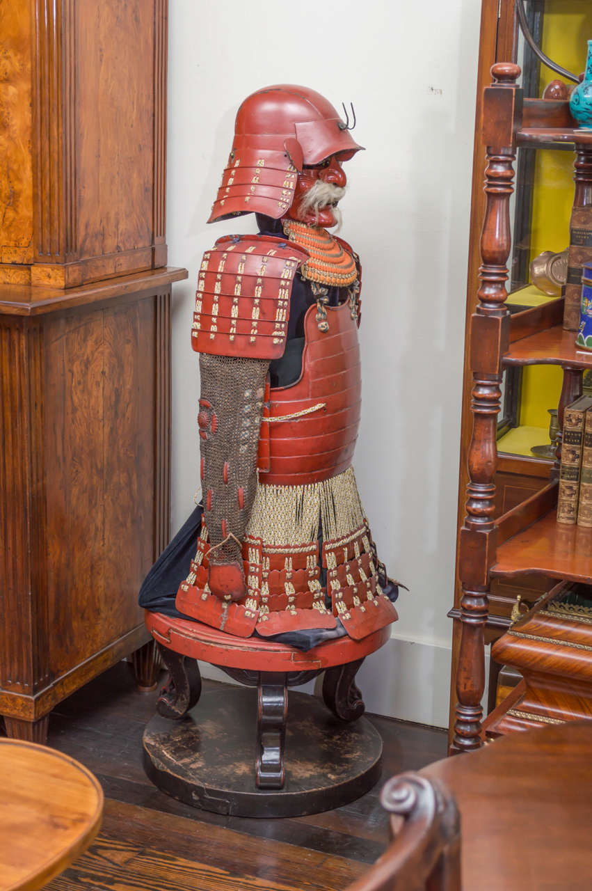 Suit of red lacquer Japanese fighting armour of the late Edo period, (1716-1868). Desirable coral red lacquer is original and unrestored.
Composed of a helmet, (Kabuto) breast plate (Do) and shoulder, arm protection (chainmail). Displayed with a