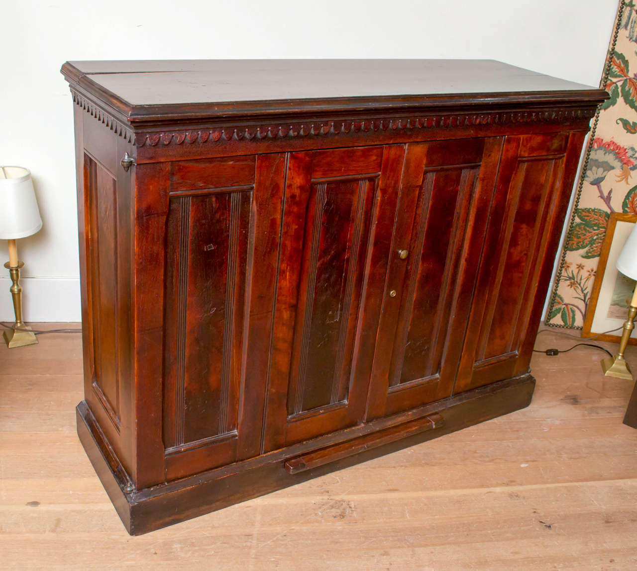 Late 19th century English Victorian file cabinet. 24 separate drawers of solid walnut behind bi-fold doors. Solid walnut and secondary woods. Metal hardware to hold files can be removed from drawer interiors.