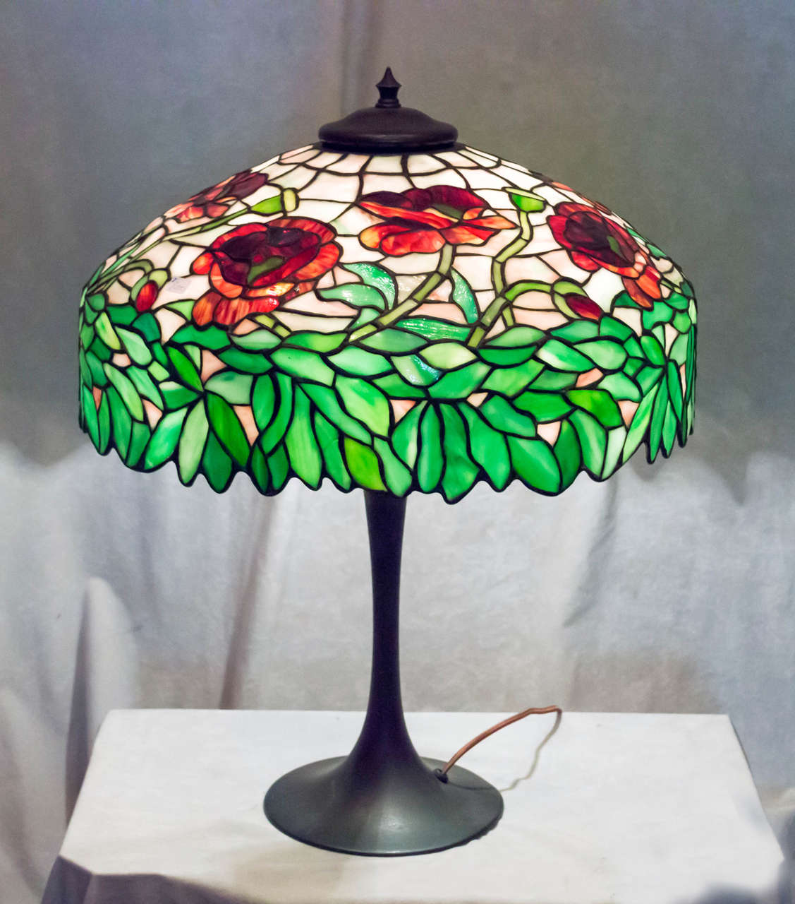 This very colorful leaded glass table lamp is attributed to the 