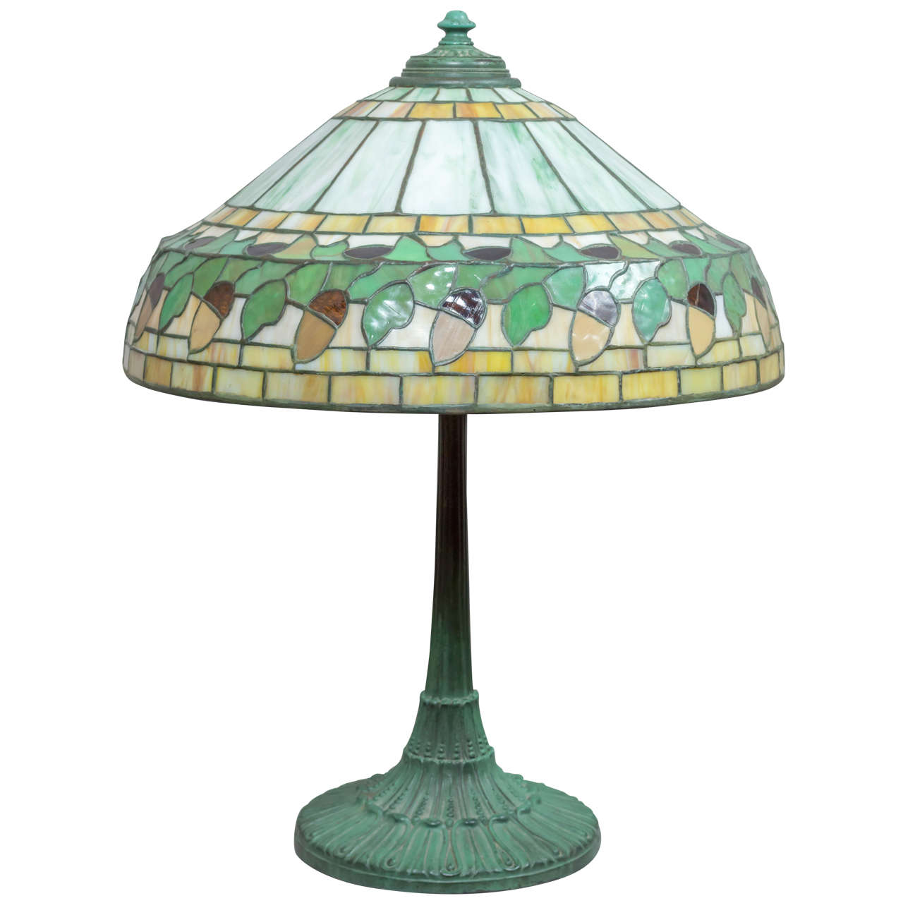 This very nice example of the work of the Wilkinson Company is a rare model. With an acorn border and colorful segments of geometric patterns in light and dark green and amber. The base is one of Wilkinson's finest and having an original luscious