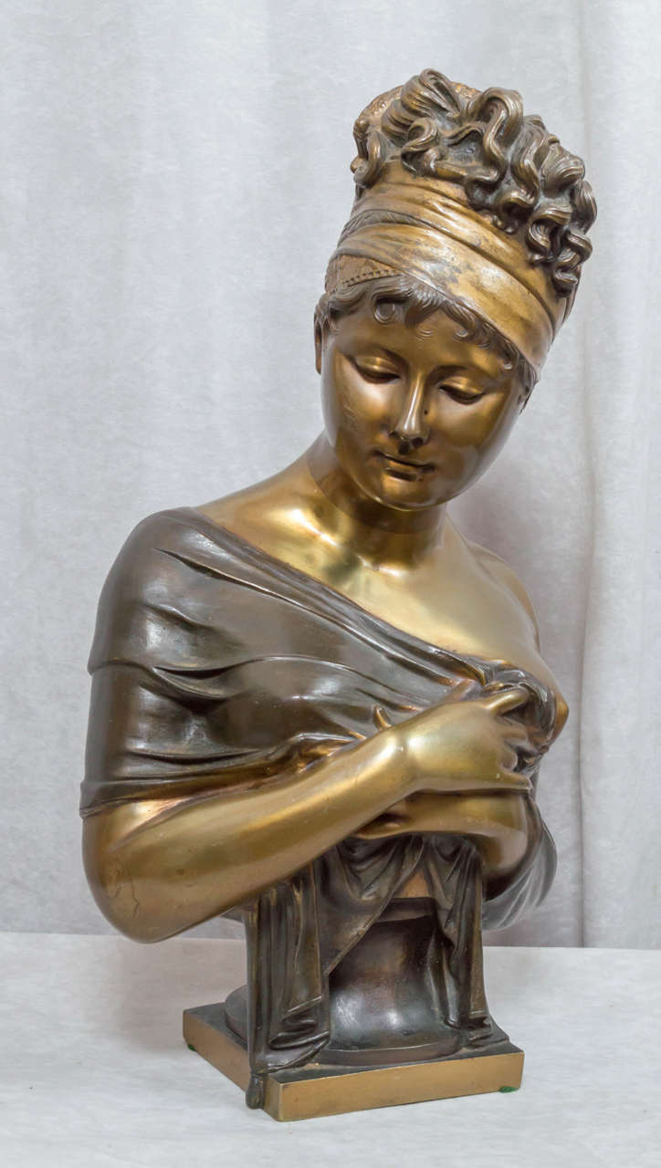 This well cast and beautifully patinated bronze of young women was done by the noted french sculptor Houdon. Houdon died in 1828, but many of his marble and plaster busts were cast later in the 19th century. The signature looks like Houton, but we