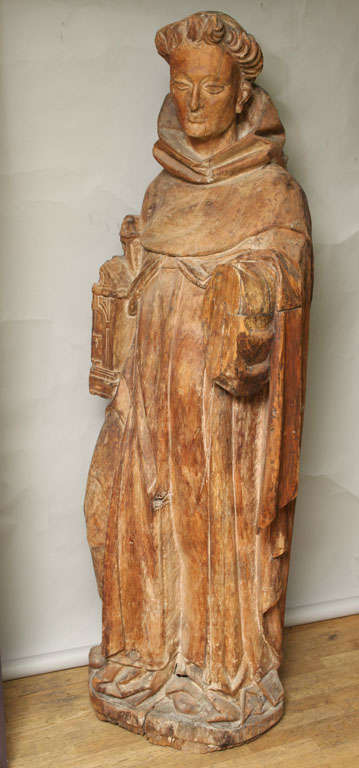 An Italian carved hardwood figure of Saint Francis dressed in traditional costume now lacking arm. Figural depictions typically show St. Francis feeding birds.