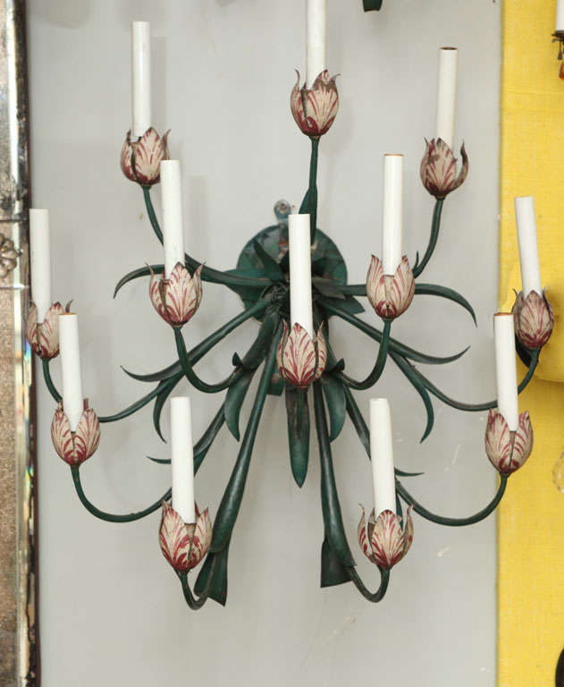 A pair of 12 light French tole peinte wall sconces with upswept candle arms in the form of tulips, the arms formed by stems with leaves and the bobeches in the form of tulips painted with naturalistic details.