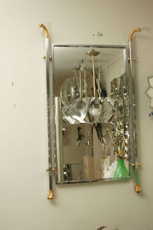 Chrome Framed Mirror with Brass Eagle Heads. View our complete collection at www.johnsalibello.com