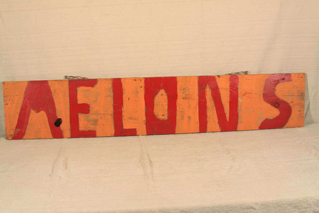 Charming and primitive, this wood sign is from a Texas roadside fruit stand and dates to the 1960s. Crude hand-lettering in bright red over a soft pumpkin-color background, this piece is sized right for a casual kitchen wall or along side other