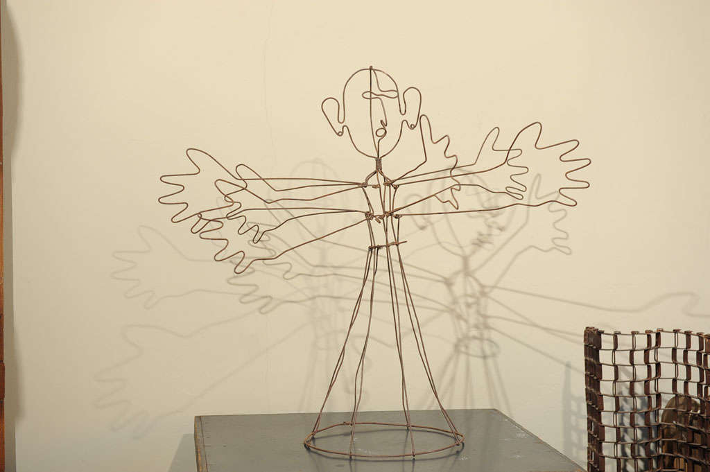 A six hand figure made from wire in the style of Alexander Calder