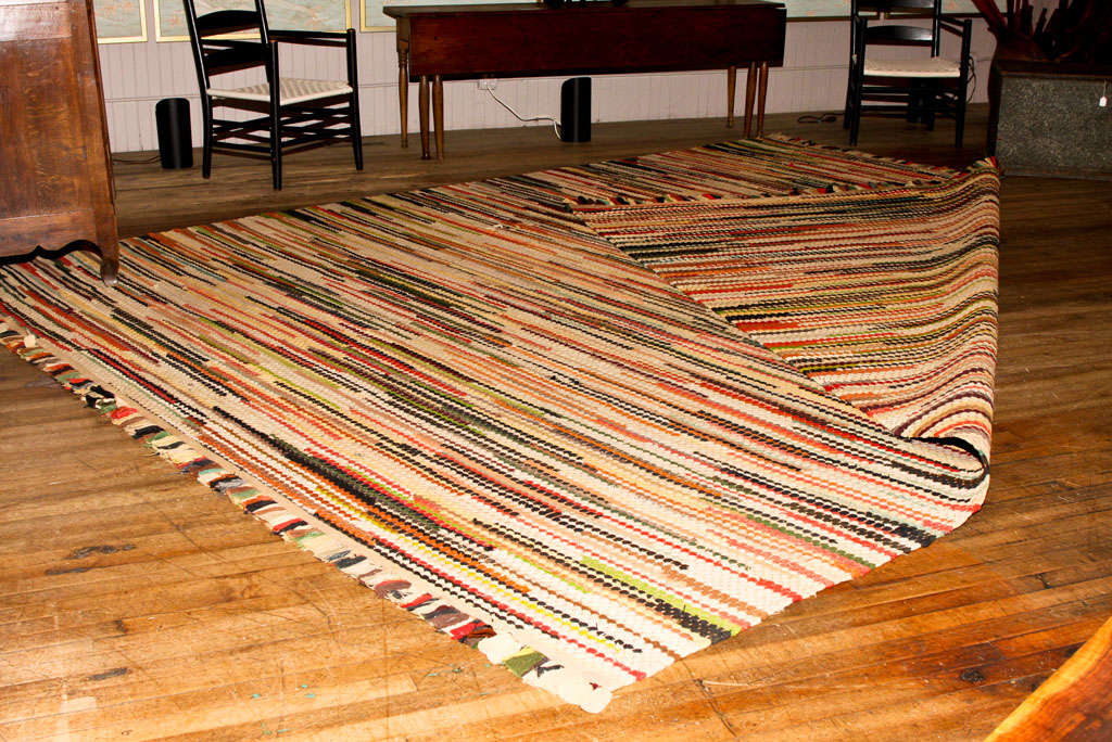 large loomed rug in rich and cheerful colors   <br />
predominant salmon highlights<br />
fringed end border<br />
reversible