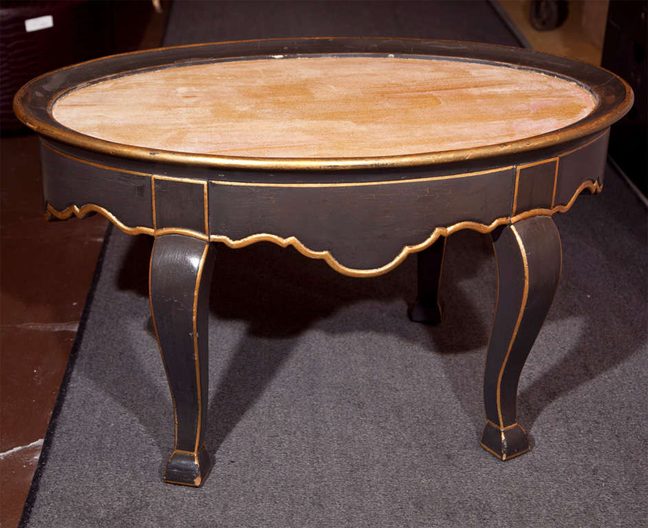 French Louis XV style coffee table, overall ebonized and parcel-gilt, the wood top table with beautiful scalloped apron, raised on cabriole legs.