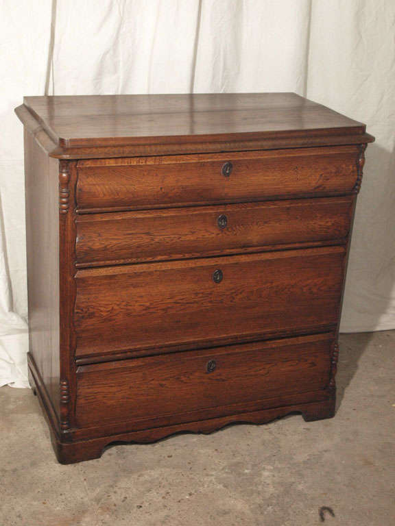 A very unique and rare period piece -- a Louis Philippe chest of drawers in beautiful French oak.  Unlike most Louis Philippe chests, this one has softly curved, slightly serpentine shaped drawers with turned beaded details on all four corners. 