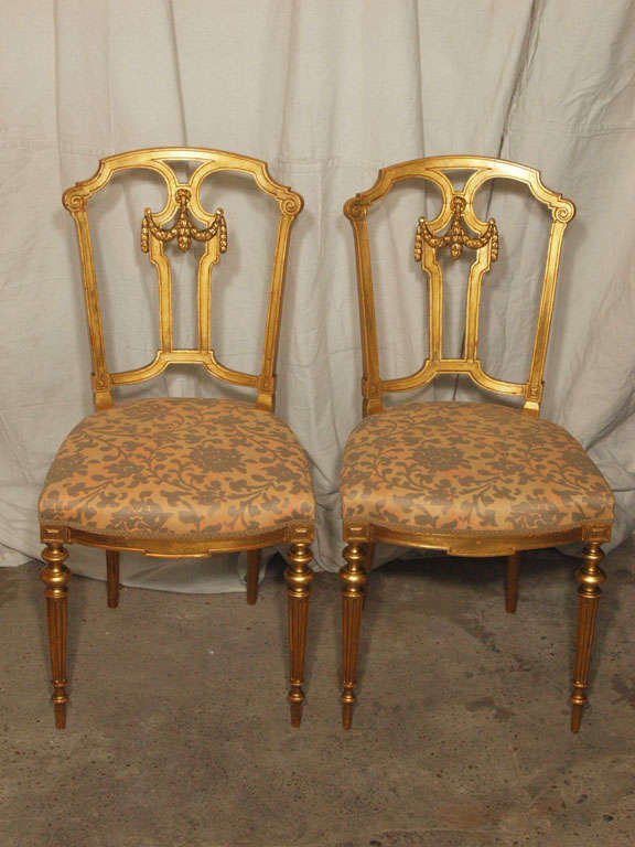 This pair of original giltwood salon or parlor chairs are absolutely breathtaking.  The water or mercury gilded frames are in amazing condition and almost look like they have been 