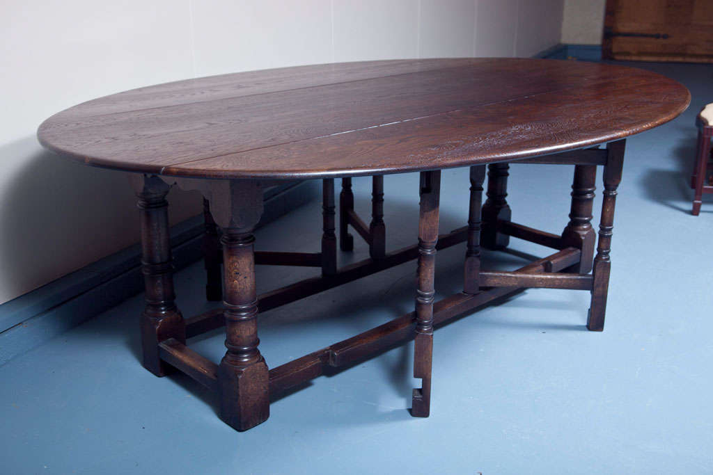 This oak gate leg table is difficult to tell from an antique, the construction and distressing of the wood and finish are that good. But we won't steer you wrong; this table was made for us most recently, another delightful creation by one of our