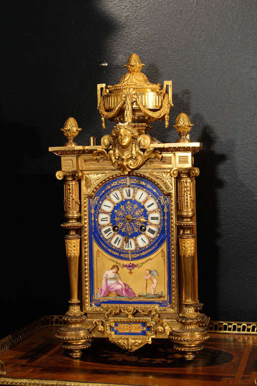 Louis XVI revival mantel clock. Painted glass panels with cupid motif. Strikes on the hour and half hour. Gilt metal.

OFFERED AT THIS 50% OFF PRICE FOR 2015 ONLY!