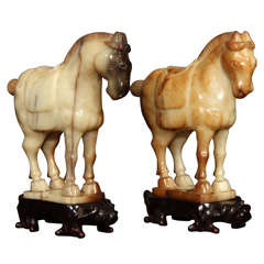 Pair of carved jade horses on stand