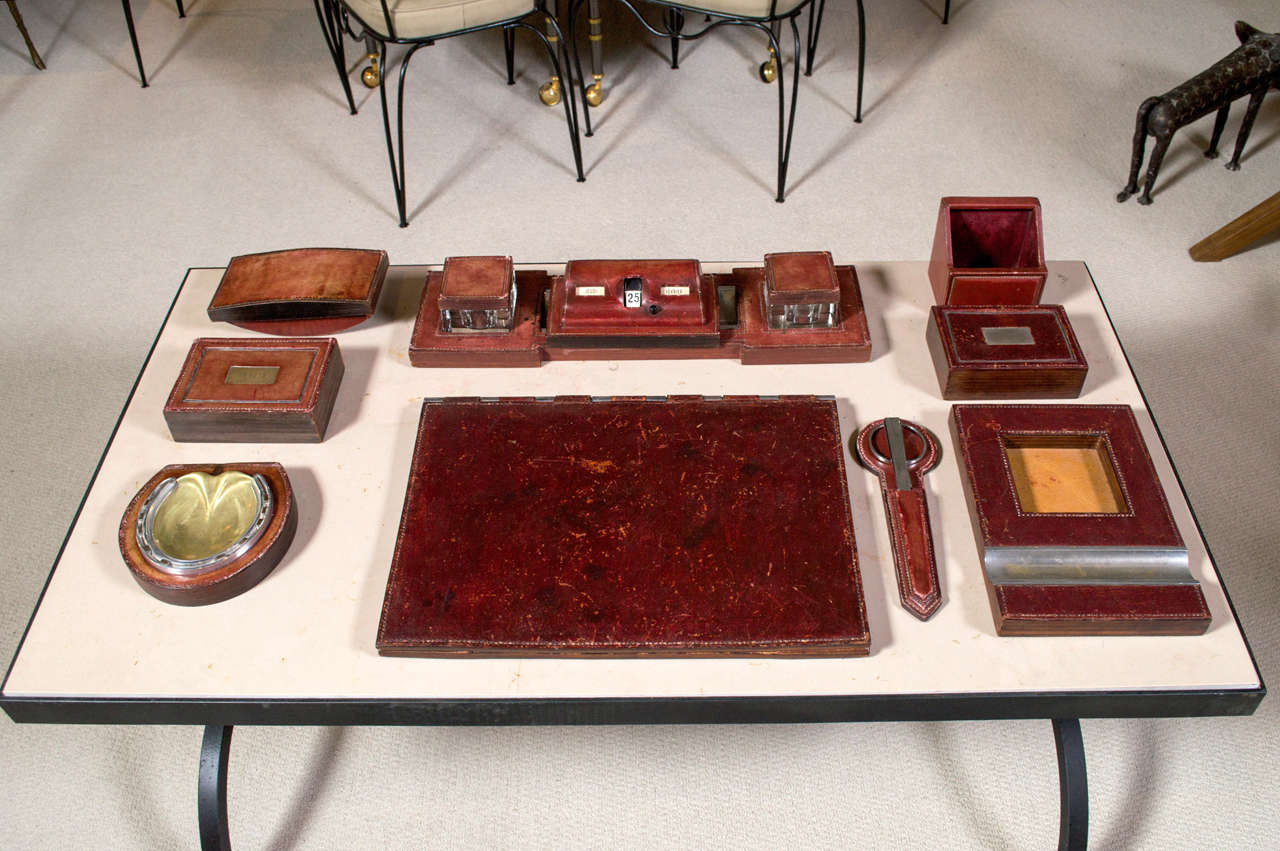 A handsome and extensive desk set by Paul Dupré-Lafon (1900-1971) designed for Hermes in rich red/brown leather with stitched detailing.
Comprised of a large writing pad, note pad, blotter, perpetual calendar, and more.
Signed: Hermes-Paris, circa