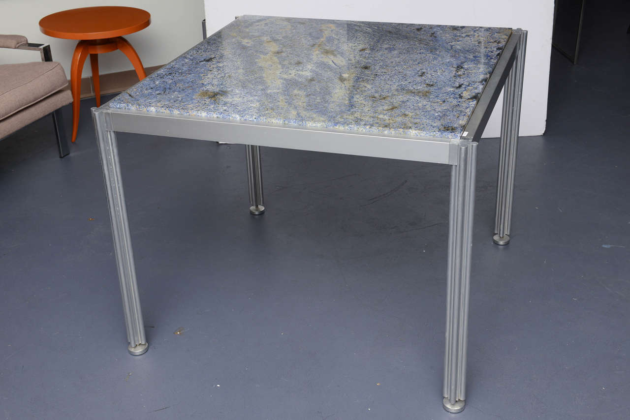Polished Aluminium structure, perfect proportions and details by G. Ciacimino, circa 1980. Blue granit top.
Four leaves clover shaped legs.
Editor 