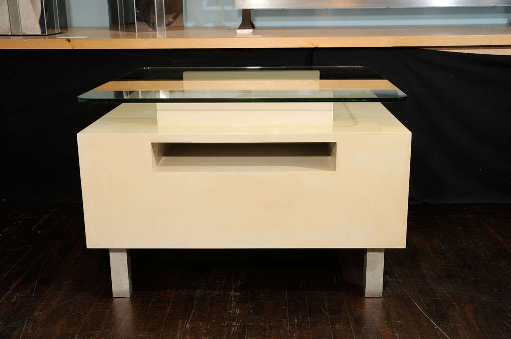 White-lacquered wood.  Architectural form with glass top, recessed front compartment, and brushed metal legs.
*Although this design dates back to the 1950s, this particular table was executed ca. 1966 for a private residence in Beverly Hills,