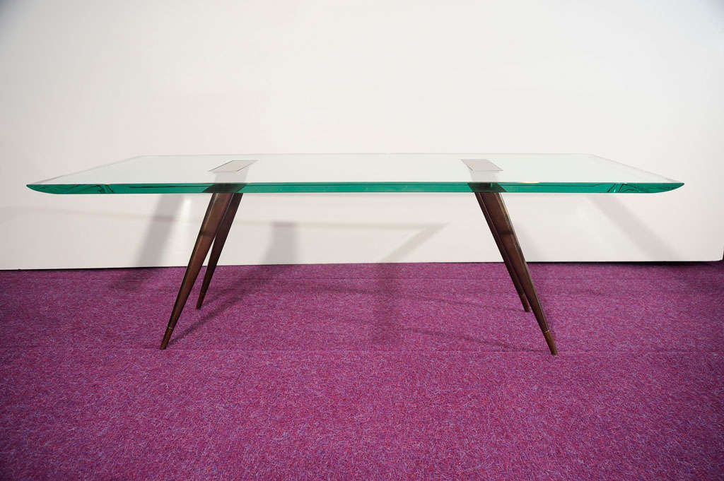 Rectangular cocktail table with sculpted crystal top, and patinated brass legs and mounts.  Polished brass tips to legs.  This rare table is pictured in Fontana Arte's catalog from the late 50's and listed as item #1817/1.