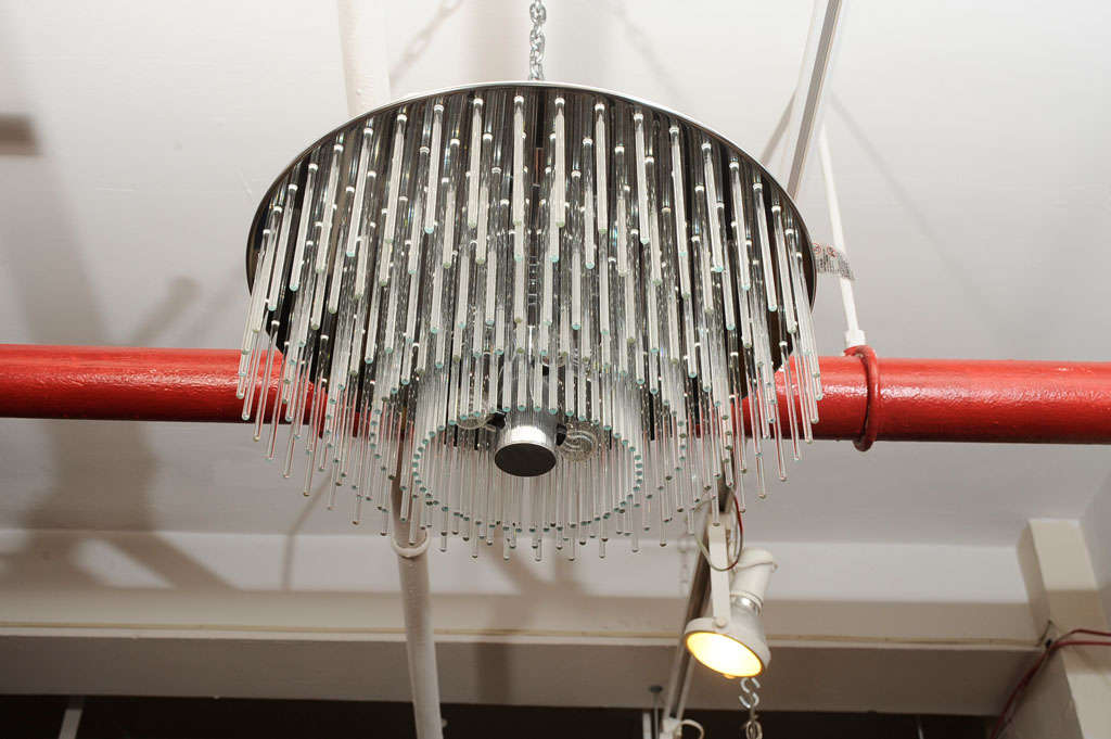 240 glass rods suspended in a perforated chrome disk. 6 chandelier sockets on center tubular chrome piece. Original Lightolier label still attached. Can be mounted flush to the ceiling or suspended as a chandelier.