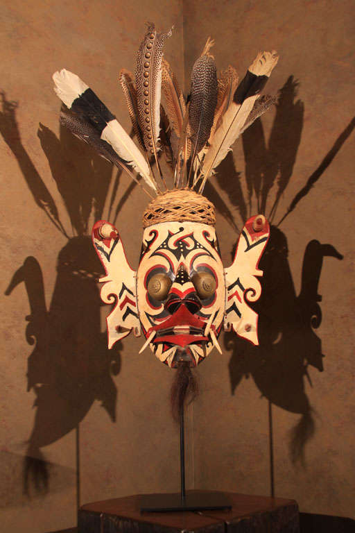 Fine Hudok/Hudoq mask of carved wood with original pigments, shell eyes and feathered headdress. A mythological composite of both human and  zoomorphic elements. Used primarily at harvest ceremonies to welcome benign argicultural spirits and scare