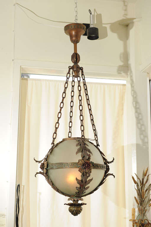 This very special orb fixture would just bring tremendous presence to an entryway or any other room.  We've never seen anything quite like it.  Note the beautiful metal work which still maintains much of its original paint.  This almost looks like