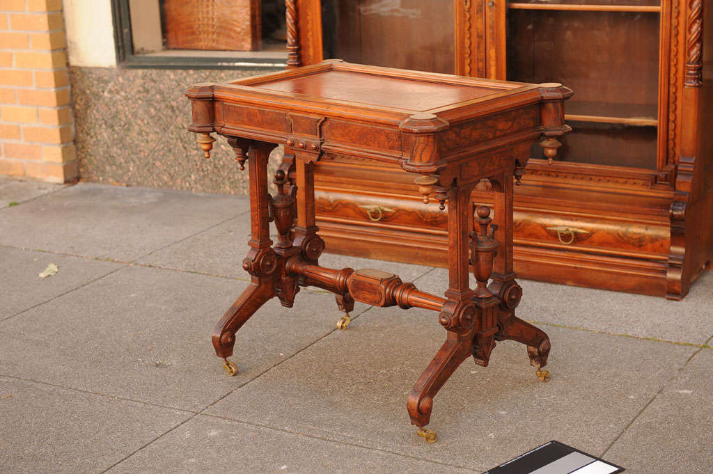 The most desirable of the Victorian period is the Renaissance Revival style.  This has beautiful elements, burl highlights, and an inlaid leather top.  It also has a drawer.