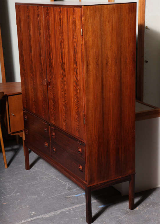 Danish Modern Rosewood Hutch by Niels Moller.  Features height adjustable interior shelves, 4 drawers, pull out trays, and bisected box pulls.  Serves many functions including as a china or linen cabinet, bar, buffet, or wardrobe.