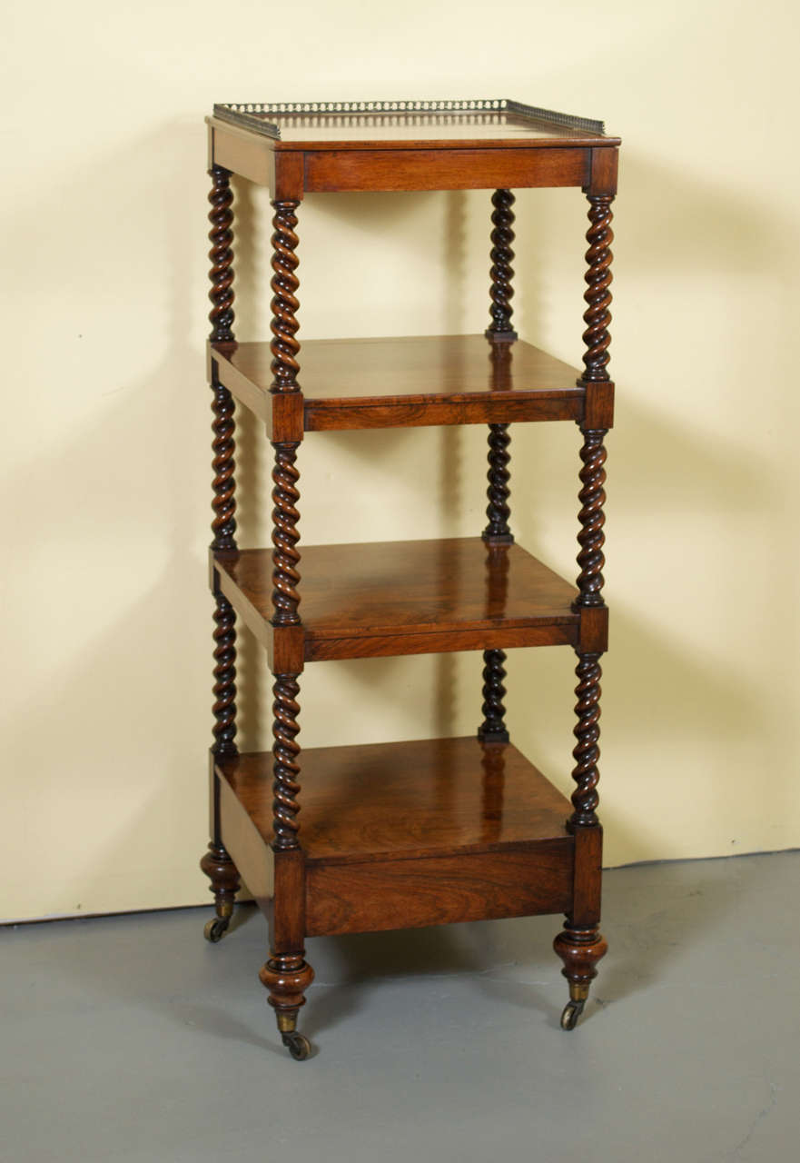 A gorgeous Victorian rosewood whatnot. This étagère has four tiers that are connected by barley twist turned supports. The top tier has a brass gallery and the piece rests on four brass castors. This whatnot retains it beautiful, rich, original