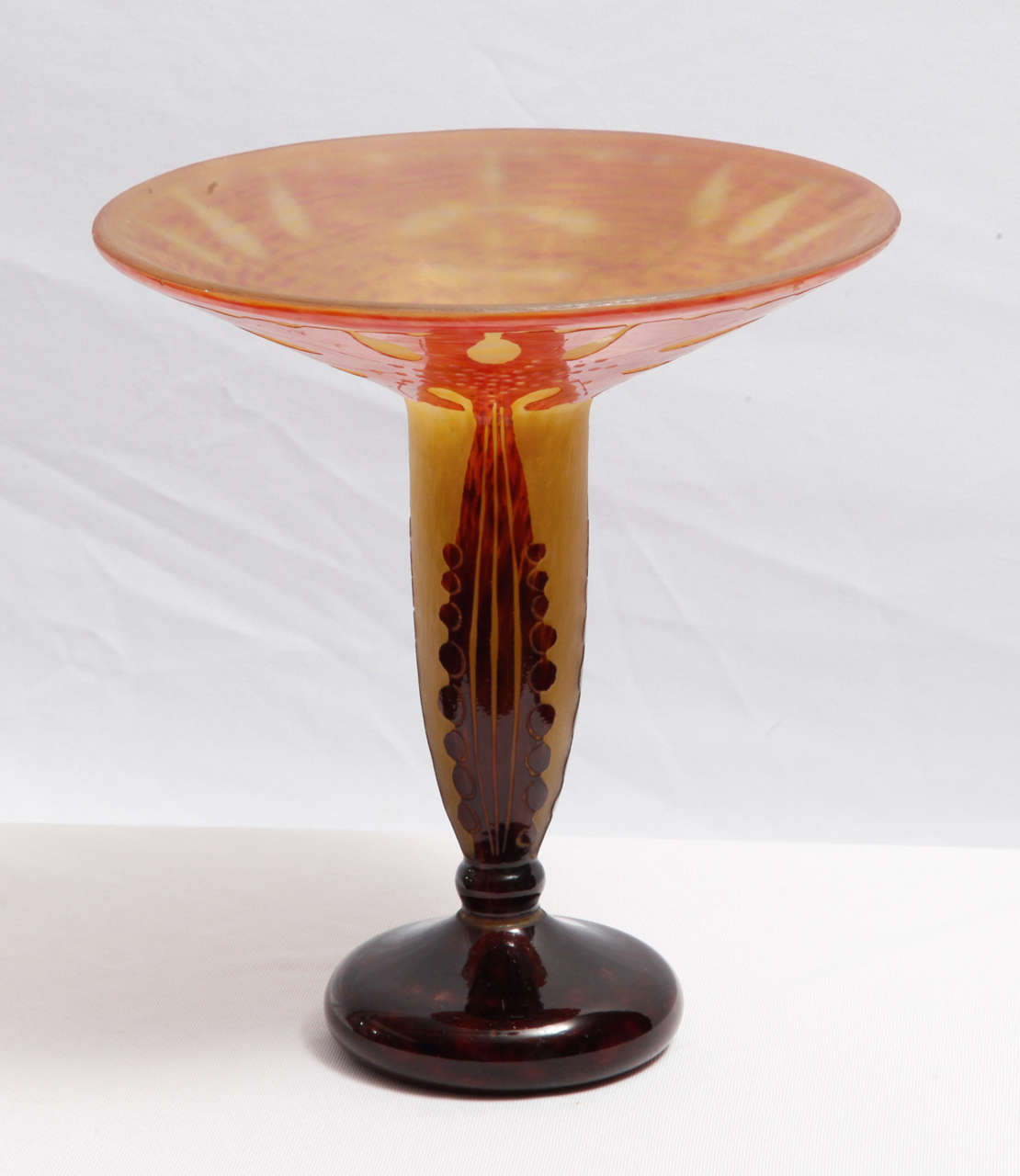 Elegant glass foot vase on a foot executed by 'Le Verre Français' the famous brand of the French designer Charles Schneider.
Cameo (etched and curved) 'Amaranthe' pattern decor in fused layers of red, purple and yellow glass. Engraved signature on