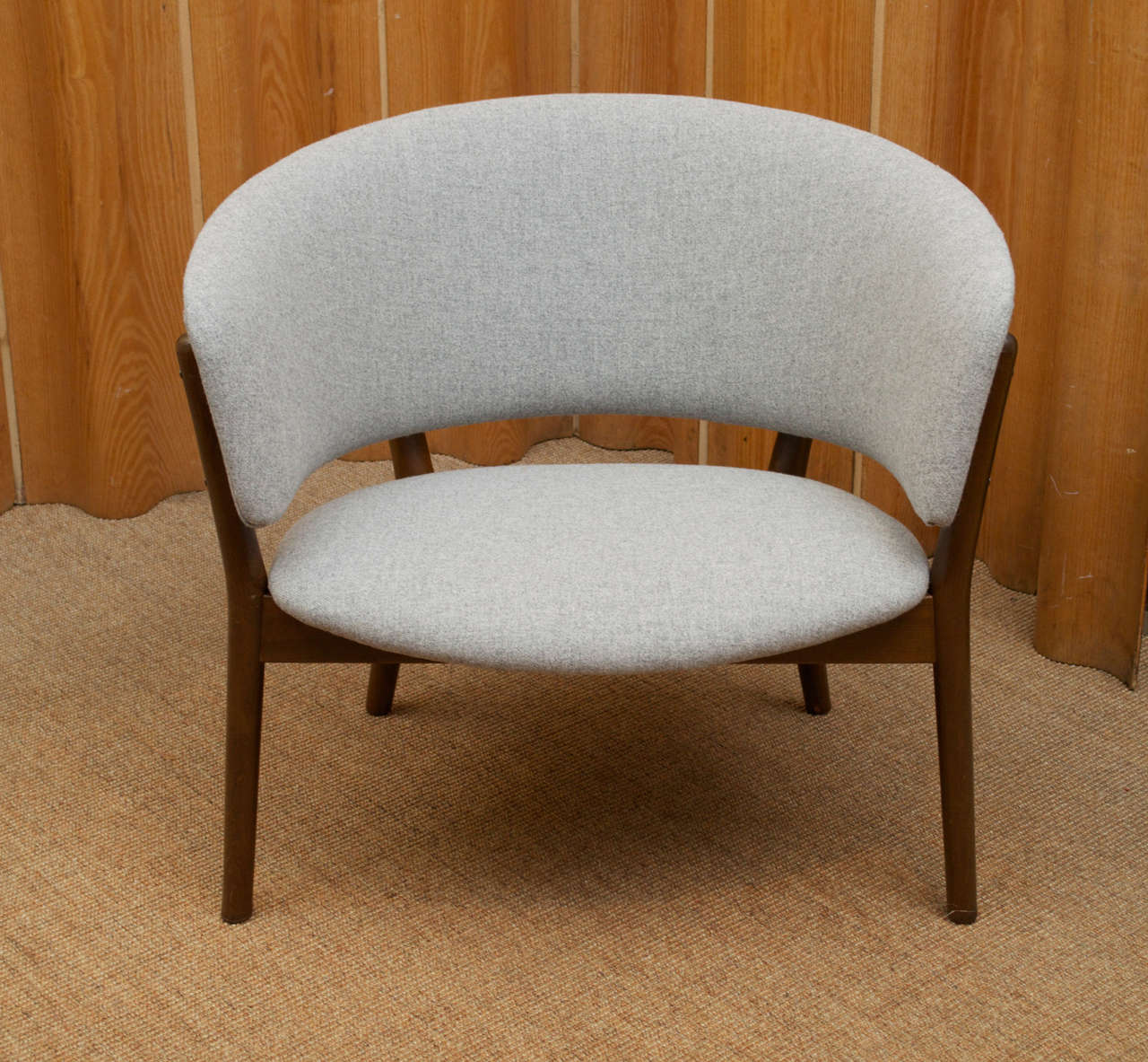 Outstanding lounge chair designed by Nanna Ditzel. Newly upholstered in light grey wool fabric.