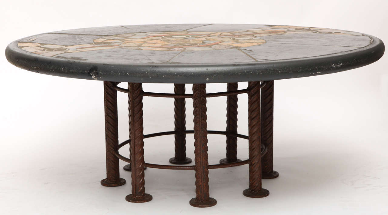 A modernist ceramic table with brass inlay, iron base signed APN 91.