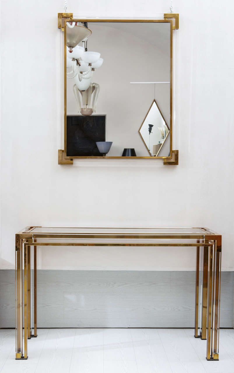Rectangular Consolle with glass top.
The structure is in Gold brass and lucite .
Also finished on the back can be put in the centre of a room or detached from the wall.
h inch 29 L inch 47 D inch 16
The mirror frame's is on gold brass and