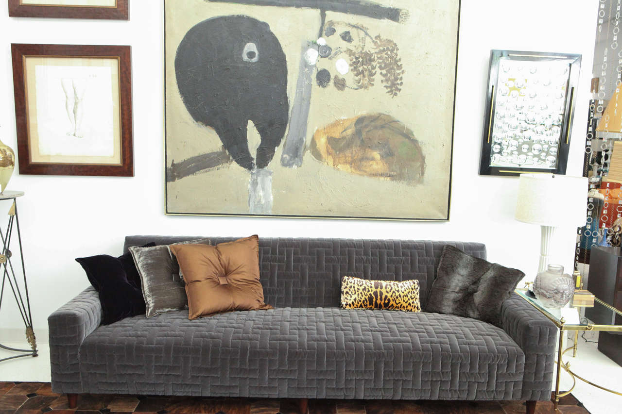 A chic custom designed sofa by William Haines, designed for the Beverly Hills home of Dr. Herbert and Mrs. Rita LeRoy Roedling. It has been newly upholstered in a beautiful graphite cotton velvet that was custom quilted using one of Haines' archived